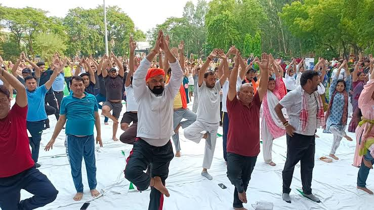 Person meditating in lotus pose during peaceful sunset, representing inner peace and spiritual practice